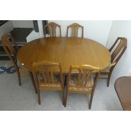 384 - A G-Plan teak dining table, raised on turned, tapered legs  29