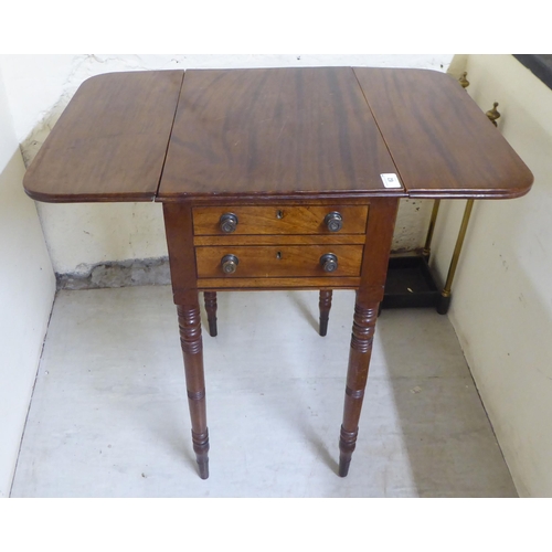 62 - A late 19thC mahogany Pembroke work table with two end drawers, raised on ring turned, tapered legs ... 