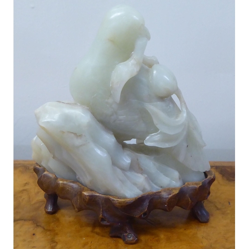 63 - A 20thC carved jade coloured hardstone model, a bird  4