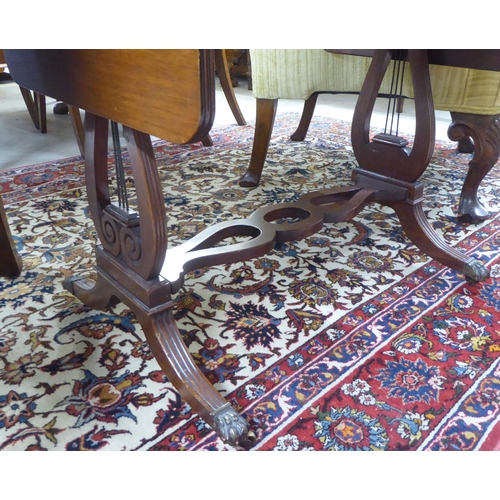 75 - A mid 20thC William IV style mahogany sofa table design occasional table, raised on lyre ends and sp... 