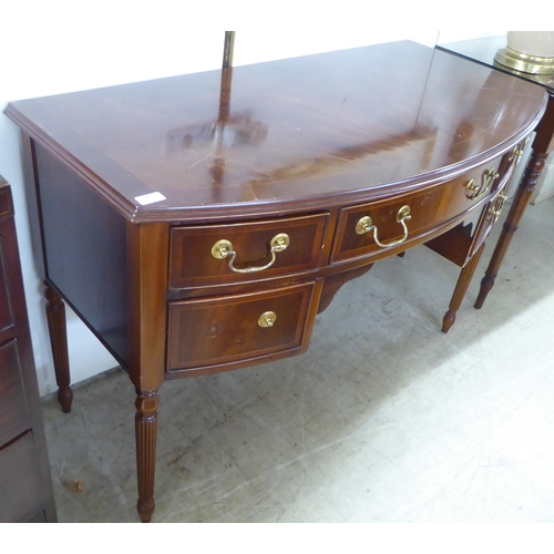 78 - A modern reproduction of a Georgian design string inlaid mahogany finished, bow front five drawer kn... 