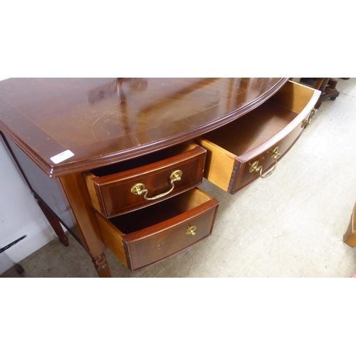 78 - A modern reproduction of a Georgian design string inlaid mahogany finished, bow front five drawer kn... 