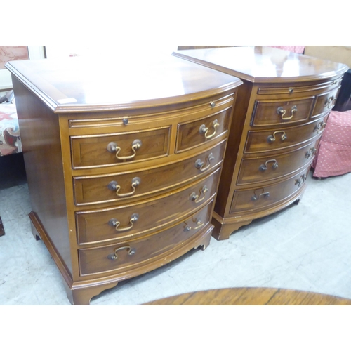 79 - A pair of modern yewwood bowfront five drawer bedside chests, raised on bracket feet  26