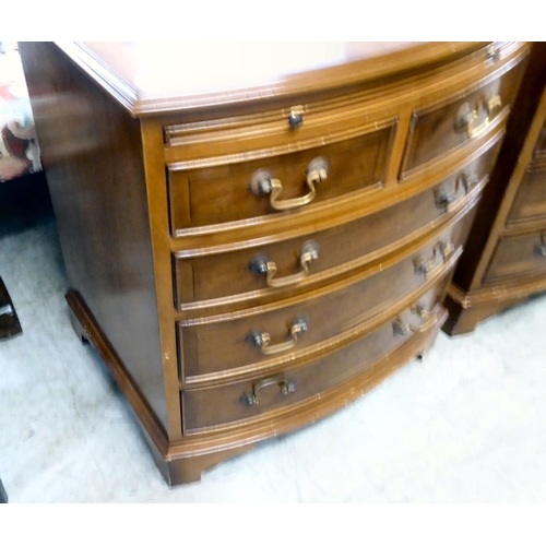 79 - A pair of modern yewwood bowfront five drawer bedside chests, raised on bracket feet  26