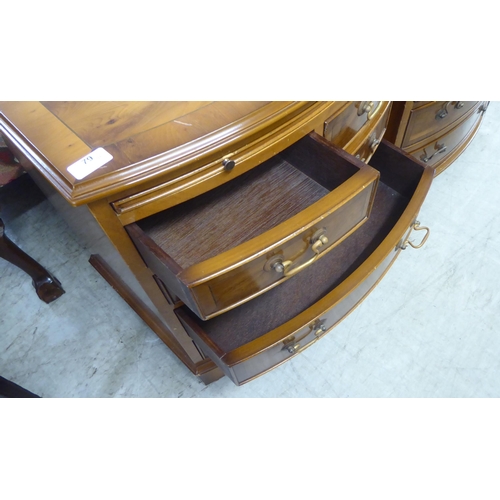 79 - A pair of modern yewwood bowfront five drawer bedside chests, raised on bracket feet  26