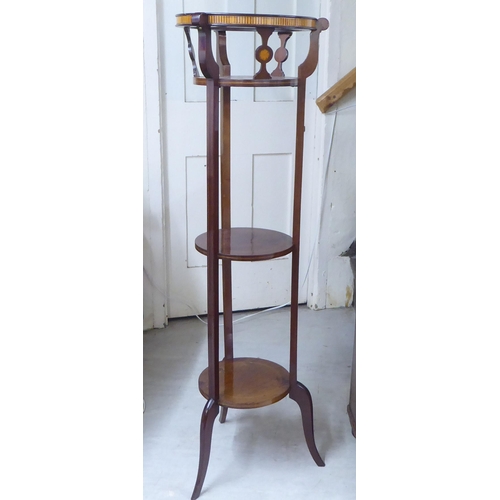 91 - An Edwardian string inlaid mahogany three tier plant stand, raised on splayed feet  47