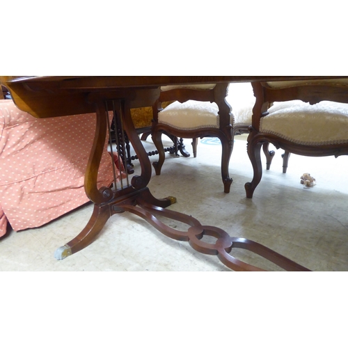 94 - A modern reproduction of a Georgian string inlaid mahogany sofa table, raised on lyre shaped ends, s... 