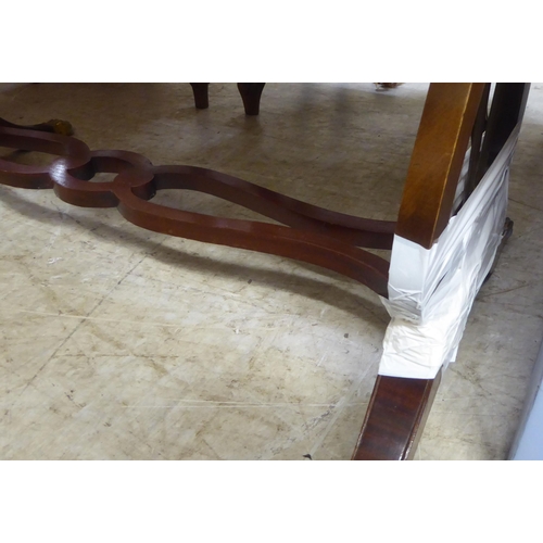 94 - A modern reproduction of a Georgian string inlaid mahogany sofa table, raised on lyre shaped ends, s... 