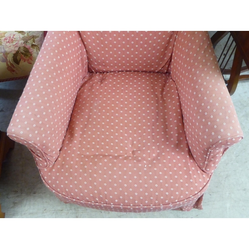 99 - An early 20thC and later fabric covered nursing chair, raised on square, tapered legs and casters&nb... 