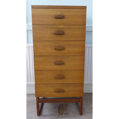 103 - A G-Plan teak dressing chest with six drawers, raised on splayed legs  45