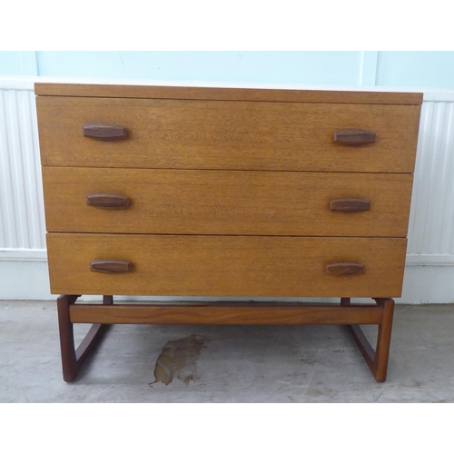 104 - A G-Plan teak dressing chest with three drawers, raised on splayed legs  28