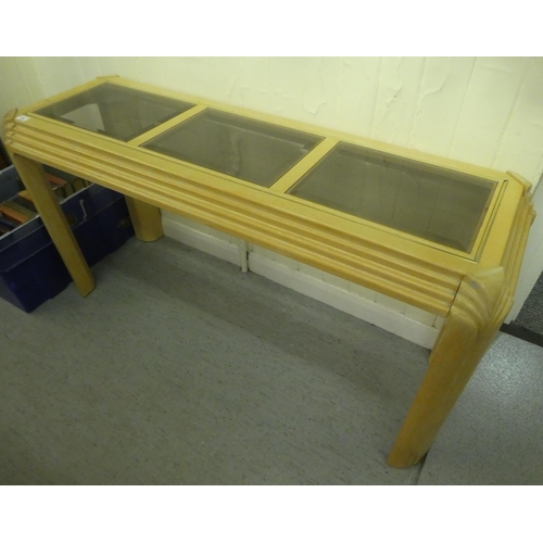 159 - A modern stained beech hall table with a panelled glass top, raised on chamfered legs  28