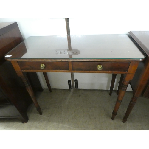 73 - A late 19thC mahogany two drawer side table, raised on ring turned, tapered legs  29