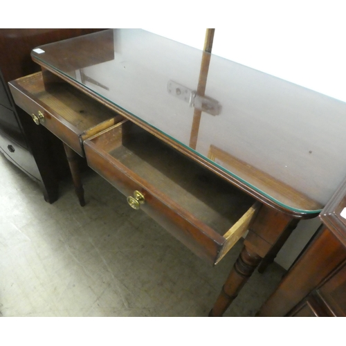 73 - A late 19thC mahogany two drawer side table, raised on ring turned, tapered legs  29