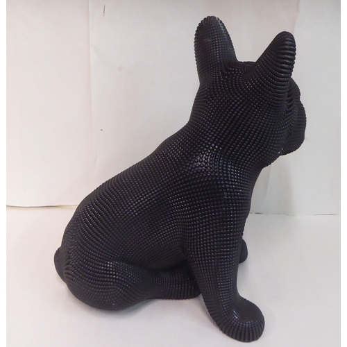 121 - A black textured composition model, a seated dog&nbsp; 18