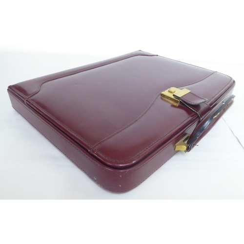 122 - Three similar brown leather brief/camera accessories cases&nbsp;