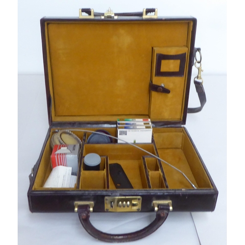 122 - Three similar brown leather brief/camera accessories cases&nbsp;