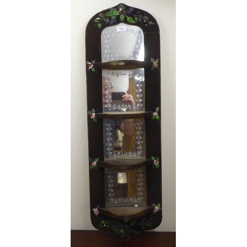 125 - A 1970s fabric covered four panelled, four shelf hanging mirror  24