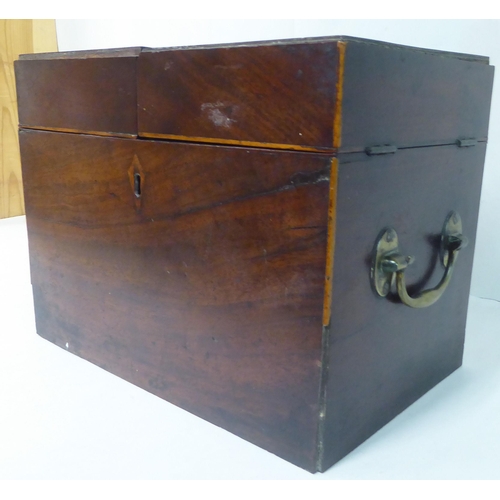 144 - A Georgian mahogany components box tantalus with straight sides and opposing brass bail handles, enc... 