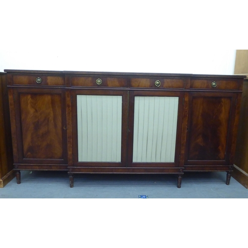 168 - A Regency style mahogany breakfront sideboard, comprising four inline short drawers, over four cupbo... 