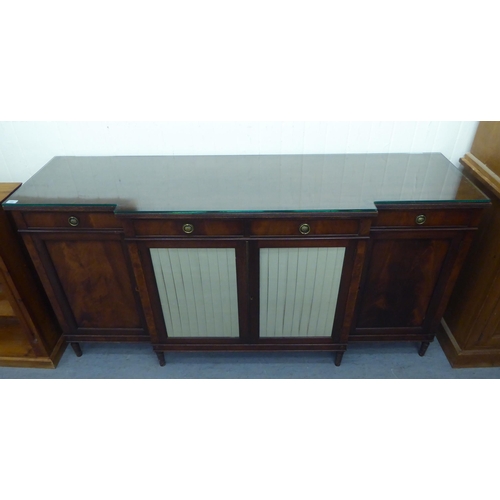 168 - A Regency style mahogany breakfront sideboard, comprising four inline short drawers, over four cupbo... 