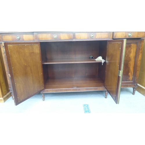 168 - A Regency style mahogany breakfront sideboard, comprising four inline short drawers, over four cupbo... 