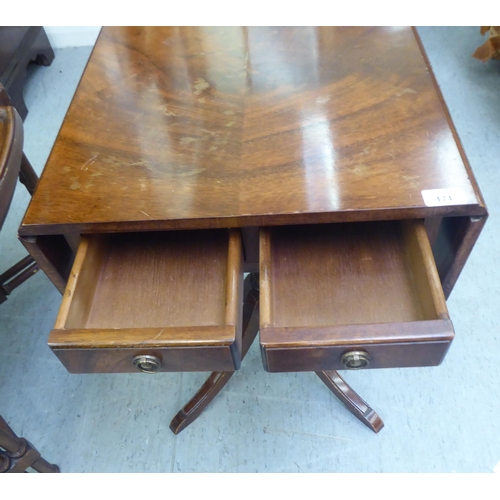 171 - A Victorian style mahogany sofa design table with fall flaps, over a pair of drawers, raised on quad... 