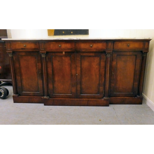 173 - A Regency style mahogany breakfront sideboard with applied pilasters and a mottled grey/white marble... 