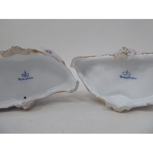 92 - A pair of 20thC Dresden porcelain double salt cellars, featuring a cherubic figure with floral decor... 