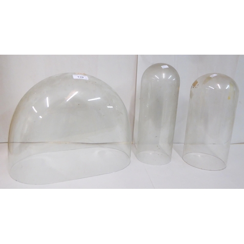 139 - Three clear glass mantel clock domes  various shapes  largest 12.5