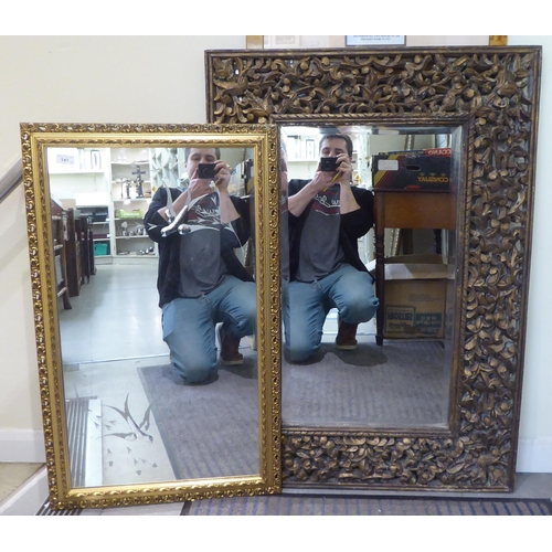 141 - Two modern mirrors, one decorated with birds in flight, set in a gilt frame  22
