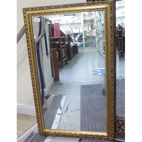 141 - Two modern mirrors, one decorated with birds in flight, set in a gilt frame  22