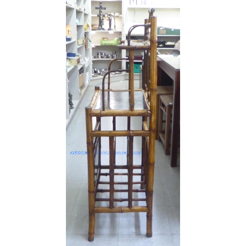 166 - A Victorian style Sino-European bamboo framed stand with shelved superstructure, over a Canterbury b... 