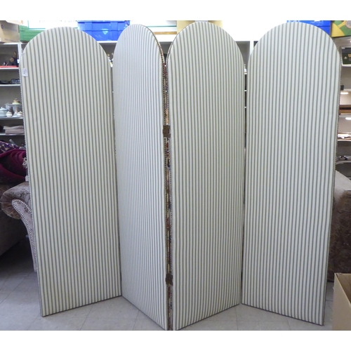 170 - A modern four fold, round arch topped room screen, stud upholstered with floral patterned and stripe... 