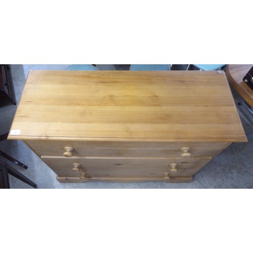 36 - A modern pine three drawer dressing chest, raised on bracket feet  32