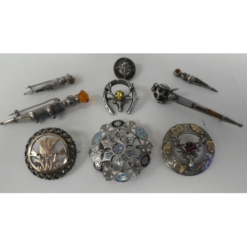 116 - Scottish pin brooches: to include Sterling and other silver and yellow metal sword brooches