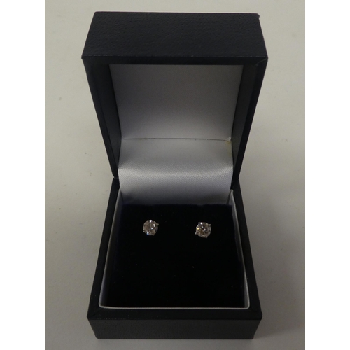 118 - A pair of 14ct white gold, claw set, single stone diamond earrings