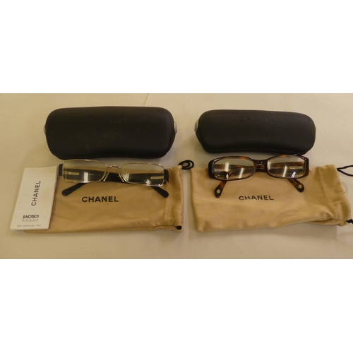 125 - Two pairs of Chanel prescription glasses, viz. a black framed pair  cased with original carton and d... 