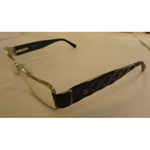 125 - Two pairs of Chanel prescription glasses, viz. a black framed pair  cased with original carton and d... 