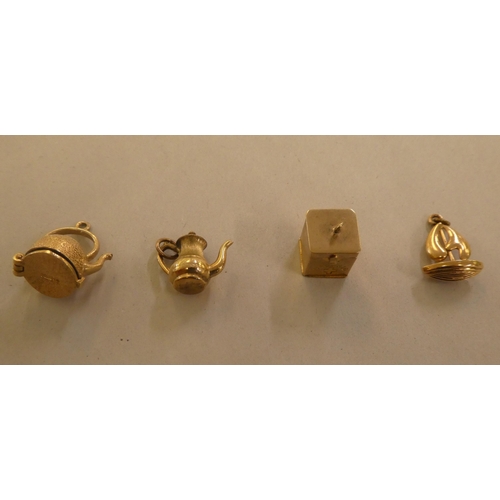 141 - 9ct gold, gold coloured and other metal bracelet charms