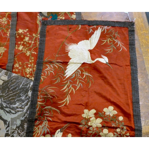 144 - Textiles: to include a set of three early 20thC Chinese embroidered panels, depicting birds  45... 