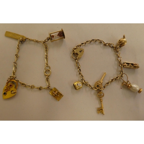 146 - Two 9ct gold, gold coloured and other metal charms, on bracelets, one with a padlock clasp