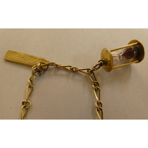 146 - Two 9ct gold, gold coloured and other metal charms, on bracelets, one with a padlock clasp