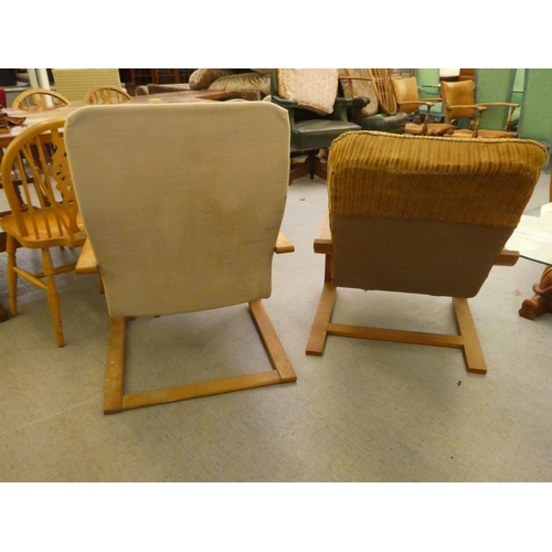 15 - Two similar mid 20thC beech framed chairs with open arms, on cantilevered underframes