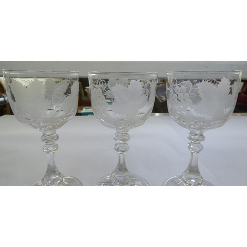 153 - A set of six pedestal wine glasses, engraved with fruiting vine  5.5