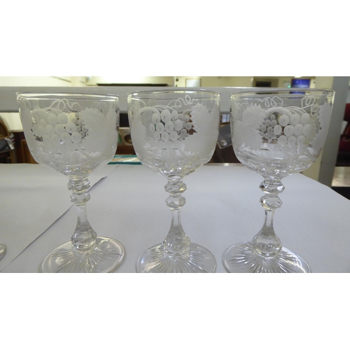 153 - A set of six pedestal wine glasses, engraved with fruiting vine  5.5