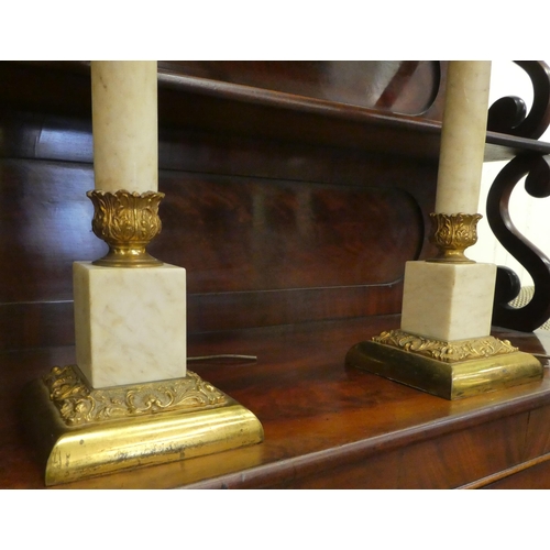 167 - A pair of gilt metal and onyx table lamps with Corinthian columns, on a plinth  18