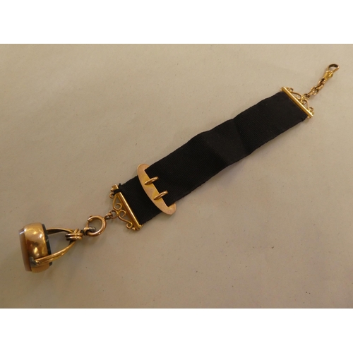 191 - A late Victorian 9ct gold and black fabric seal fob and strap&nbsp;