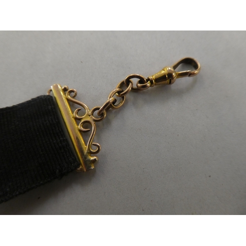 191 - A late Victorian 9ct gold and black fabric seal fob and strap&nbsp;