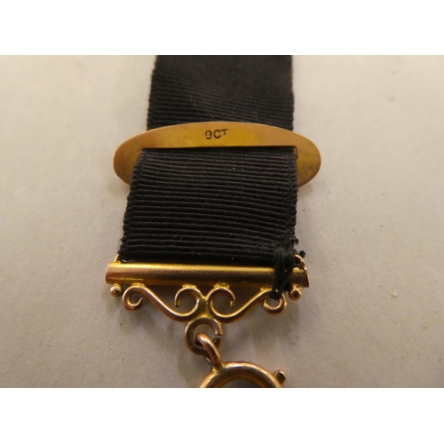 191 - A late Victorian 9ct gold and black fabric seal fob and strap&nbsp;